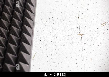 Two backgrounds on one wall. Professional soundproofing and plain white wall in a light pattern. Texture. Background. Template.Horizontal Stock Photo