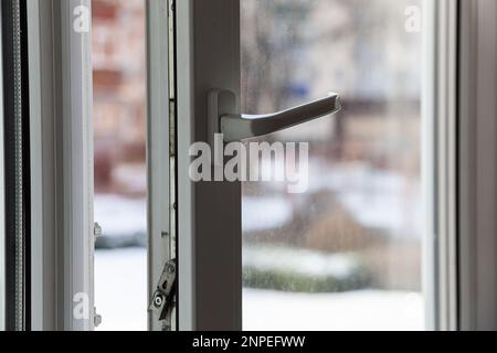 Open white plastic pvc window in winter on a cloudy day. Photo in high quality. Horizontal. Background. Stock Photo