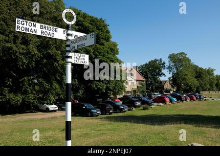 Old metal road sign post showing directions to Egton Bridge and Pickering near the Mallyan Spout Country House Hotel. Stock Photo