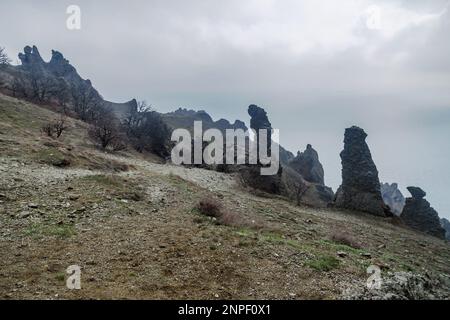 Gingerbread horse rock and bizarre rocks in Dead city. Khoba-Tele Ridge of Karadag Reserve in early spring. Crimea Stock Photo