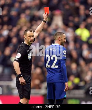 Referee Stuart Attwell shows a red card to Chelsea’s Hakim Ziyech before overturning it after checking the pitchside VAR monitor during the Premier League match at the Tottenham Hotspur Stadium, London. Picture date: Sunday February 26, 2023. Stock Photo