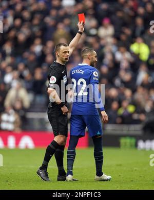 Referee Stuart Attwell shows a red card to Chelsea’s Hakim Ziyech before overturning it after checking the pitchside VAR monitor during the Premier League match at the Tottenham Hotspur Stadium, London. Picture date: Sunday February 26, 2023. Stock Photo