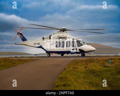 Tórshavn, Faroe Islands - July 2021: Helicopter lands at a landing pad near Torshavn. It is a very popular mode of transport in the Faroe Islands. Str Stock Photo