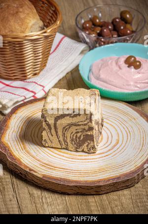 chocolate Greek halva with some fasting food like taramosalata,  bread and olives Stock Photo