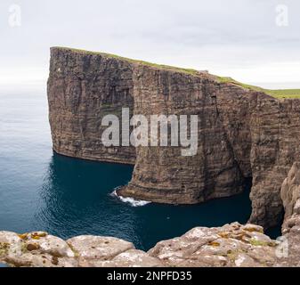 Amazing view for Slave Cliff - mountain peak, Vagar Island, Faroe Islands, Kingdom of Denmark. Stock Photo