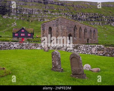 Kirkjubøur, Kirkjubour, Faroe Islands - July 2021: View for the historic cathedral of St. Magnus and cemetery near the Olaf's Church on Streymoy Islan Stock Photo