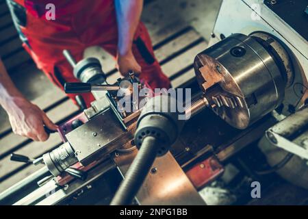 Professional Metal Worker Technician and Lathe Machine Operator. Processing Metal Elements. Stock Photo
