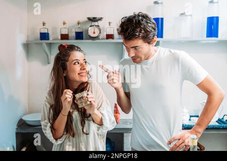 Girlfriend got caught eating desert by her boyfriend. Stock Photo