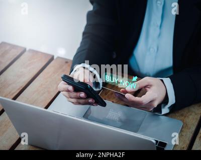Buy now, text in speech bubble appear on while business person who holding credit card and using application on mobile smart phone, online shopping  a Stock Photo