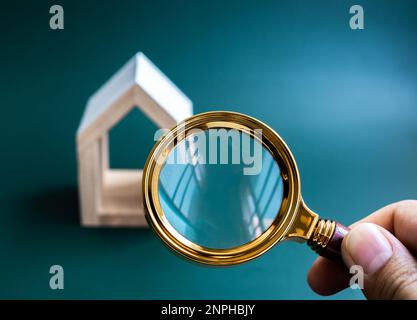 House online search, property survey, buying, selling and real estate finding concepts. Empty blank space for text or logo on lens of gold magnifying Stock Photo