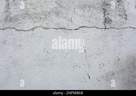 Cracked concrete wall covered with gray cement surface as background Stock Photo
