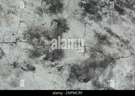 Cracked concrete wall covered with gray cement surface as background Stock Photo