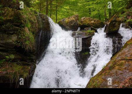 waterfall among the rocks. nature background in spring Stock Photo