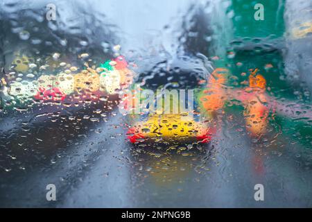 Driving in the rain. Drops on the windshield. Wet road. Police vehicle rear view. Stock Photo