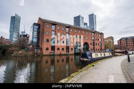 Merchants Warehouse on the Bridgewater Canal backed by the Deansgate Square complex and Beetham Tower seen in Manchester in February 2023. Stock Photo