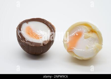 Inside of a milk and white chololate creme egg showing fondant Stock Photo
