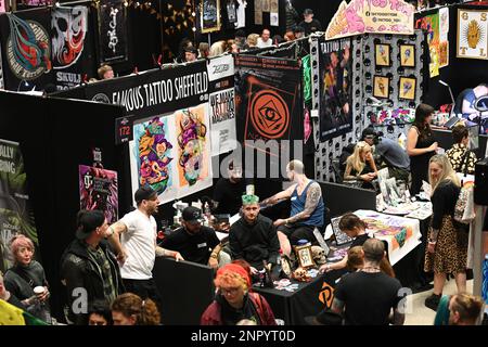 Brighton UK. 26th February 2023. Tattoo Artist's stands at the 14th Brighton Tattoo Convention at the Brighton Centre where body adornment and grooming are carried out for clients over the weekend. photo ©Julia Claxton Credit: Julia Claxton/Alamy Live News Stock Photo
