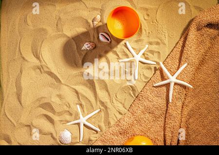 Concept of sandy beach holiday, top view. Sand background with copy space for text, flat lay. Vacation concept with souvenirs on the sand Stock Photo