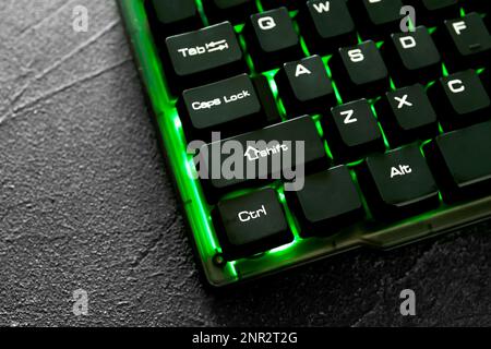Modern keyboard with RGB lighting on grey table, closeup Stock Photo