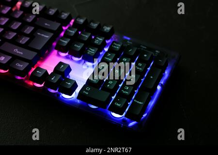Modern keyboard with RGB lighting on black table Stock Photo
