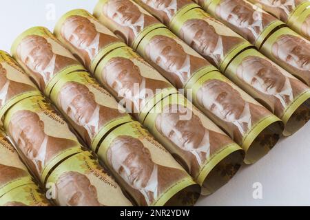Top view of rolled up and laid flat Canadian one hundred dollar banknotes with portrait of Sir Robert L. Borden former Prime Minister of Canada. Stock Photo