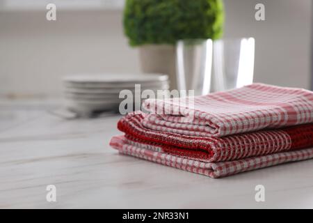 Dry kitchen towels on white marble table. Space for text Stock Photo