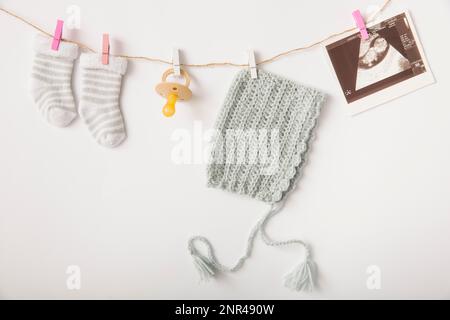 Pair socks pacifier headwear sonography picture hanging string with clothes peg Stock Photo