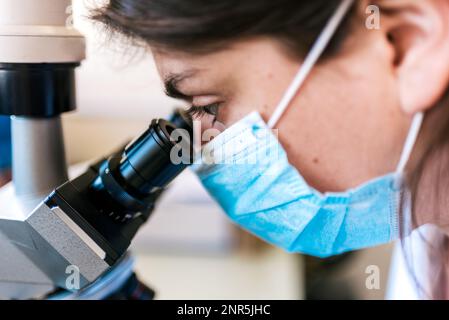 Closeup Female Scientist Using Microscopy in Laboratory Stock Photo