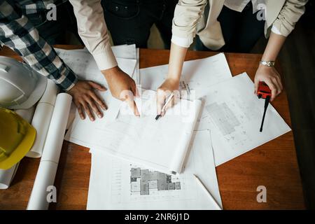 Team of architect and engineer working and discussing about new startup project on desk. Architect discuss with engineer about project  in office. Stock Photo