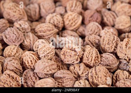 Close-up on a stack of Wenwan walnuts for sale in a market stall. Stock Photo