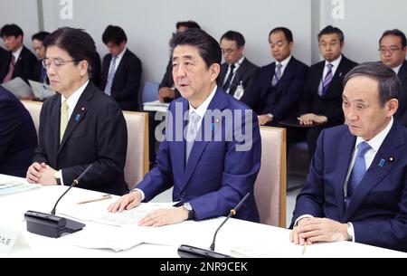 Japan's Prime Minister Shinzo Abe (C) and Minister of Health Katsunobu Kato (L) attend a meeting of New Coronavirus Infectious Disease Headquarters (task force) at the prime minister's office in Tokyo on February 13, 2020. The number of the patients who have been infected with a new coronavirus COVID-19 has reached to 48,206 and the death toll has been confirmed 1,310 so far as of February 13th in China. As the outbreak continues to spread outside China, the World Health Organization (WHO) declared the new coronavirus a Global Health Emergency on Jan 31st. ( The Yomiuri Shimbun via AP Images )