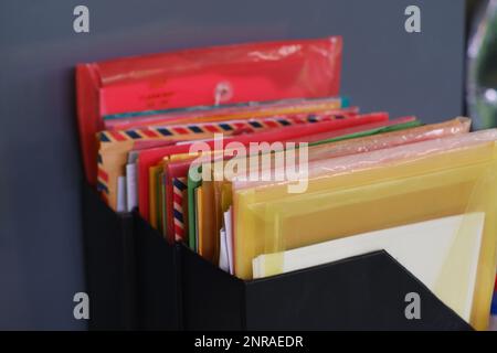 Arrangement Of Plastic Folders And Paper Folders, In A Black Bindek In The Office In The Afternoon Stock Photo