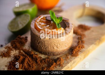 Chocolate mousse cake with a piece of candied orange decoration. Stock Photo