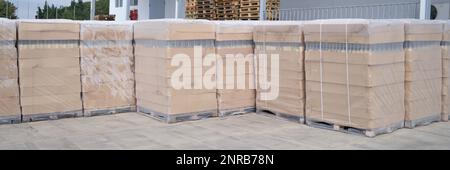 Rows of boxes and pallets in warehouse and production warehouse Stock Photo