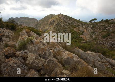 View of Montgó mountain in Spain with its cliffy, green surroundings overlooking the valley of Oliva. Stock Photo