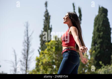 Side view of happy woman arms outstretched Stock Photo