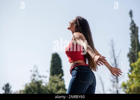 Side view of happy woman arms outstretched Stock Photo