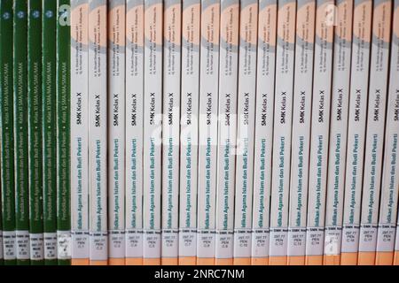 School Textbooks With White And Green Covers Arranged Tightly, On The Shelf Of The School Library, Desa Air Belo During The Day Stock Photo