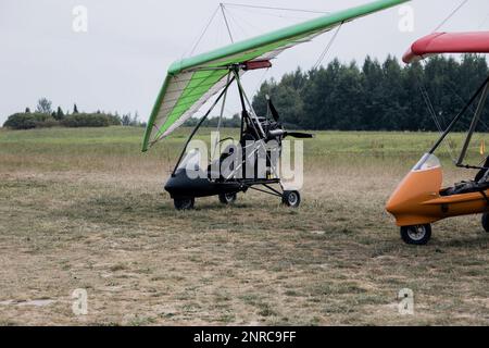A Powered hang glider at a field airport.  motorized hang on ground Stock Photo