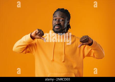 Young african man in yellow hoodie pointing on himself Stock Photo