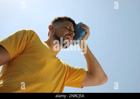 Man with cold pack suffering from heat stroke outdoors Stock Photo