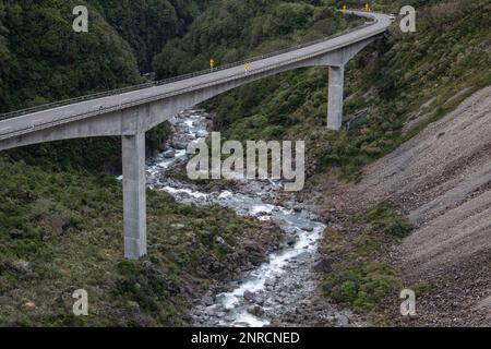 The bridge over the Otira river as seen from the viaduct overlook in the Southern Alps of New Zealand. Stock Photo