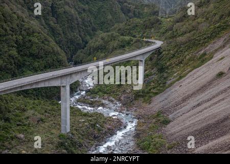 The bridge over the Otira river as seen from the viaduct overlook in the Southern Alps of New Zealand. Stock Photo