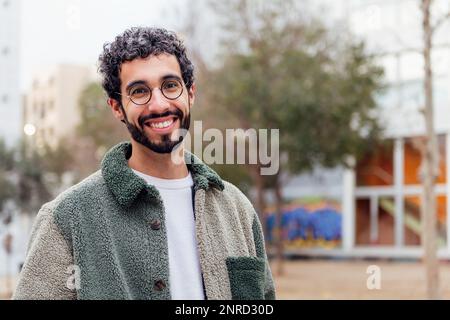 young man with beard smiling looking at camera Stock Photo