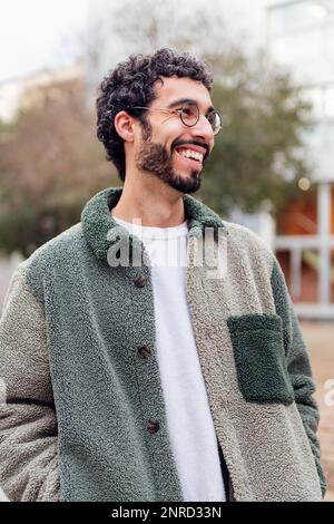 young man with beard and glasses laughing happy Stock Photo
