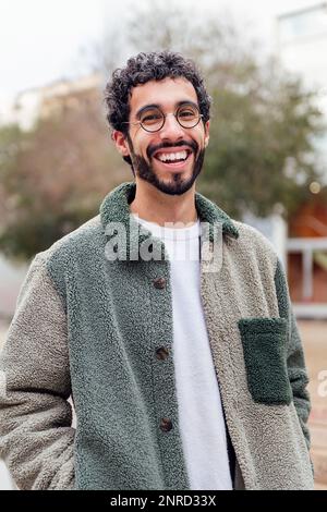young man with beard laughing looking at camera Stock Photo