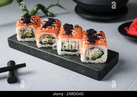 Delicious sushi rolls served on light grey table Stock Photo