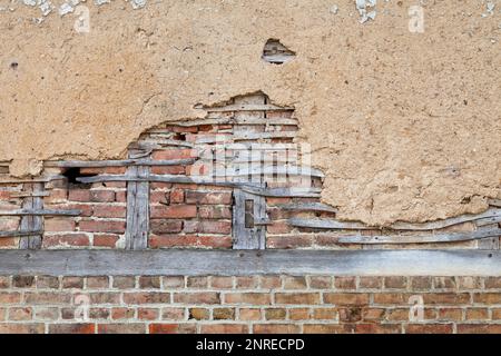Full frame close-up on a half-timbered brick wall covered with daub. Stock Photo