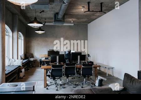 Rear view of male hacker working on computer in creative office Stock Photo