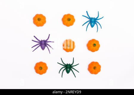 Halloween concept. Spiders and mini pumpkins on a white background. Traditional autumn holiday. flat lay, minimalism, from above Stock Photo